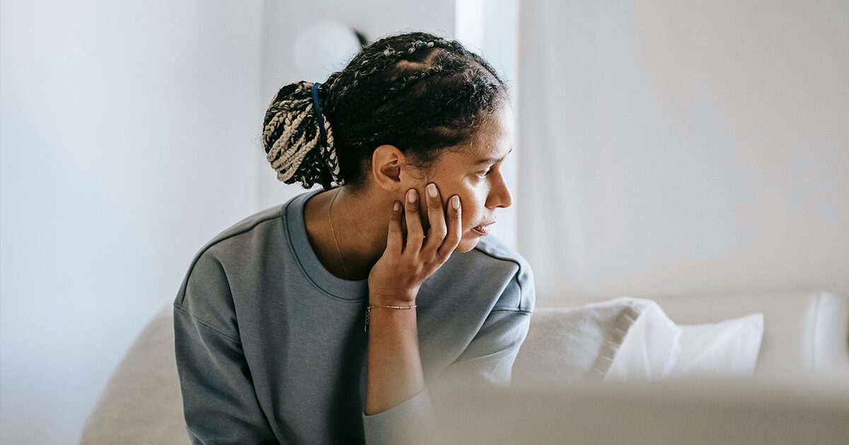 Woman sitting alone and reflecting on her post-abortion healing journey