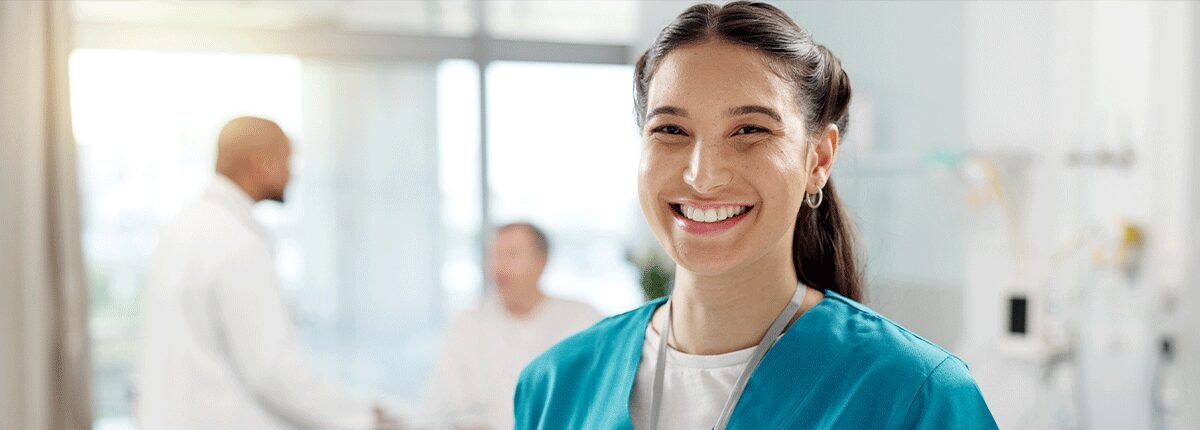 Healthcare professional holding a tablet and smiling while providing information about abortion pill reversal.